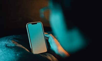 A person holding a cell phone in their hand