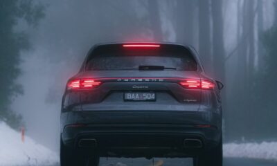 black car on snow covered road during daytime