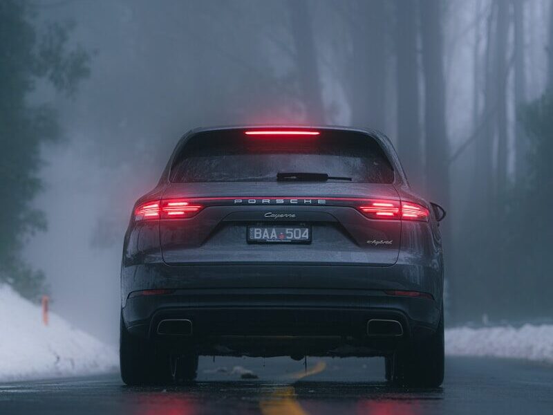 black car on snow covered road during daytime